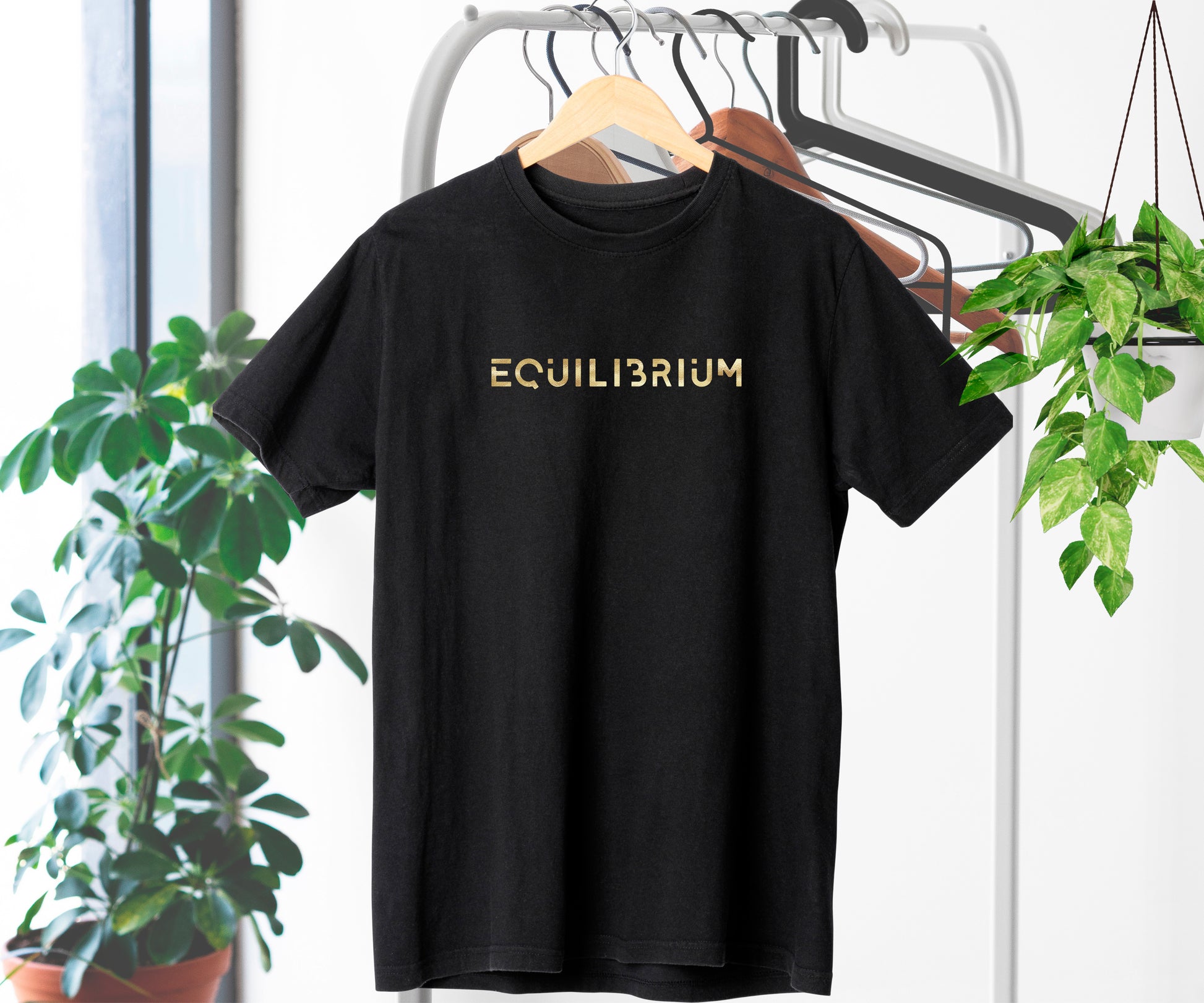 Black T-shirt with Equilibrium in gold script – centered design