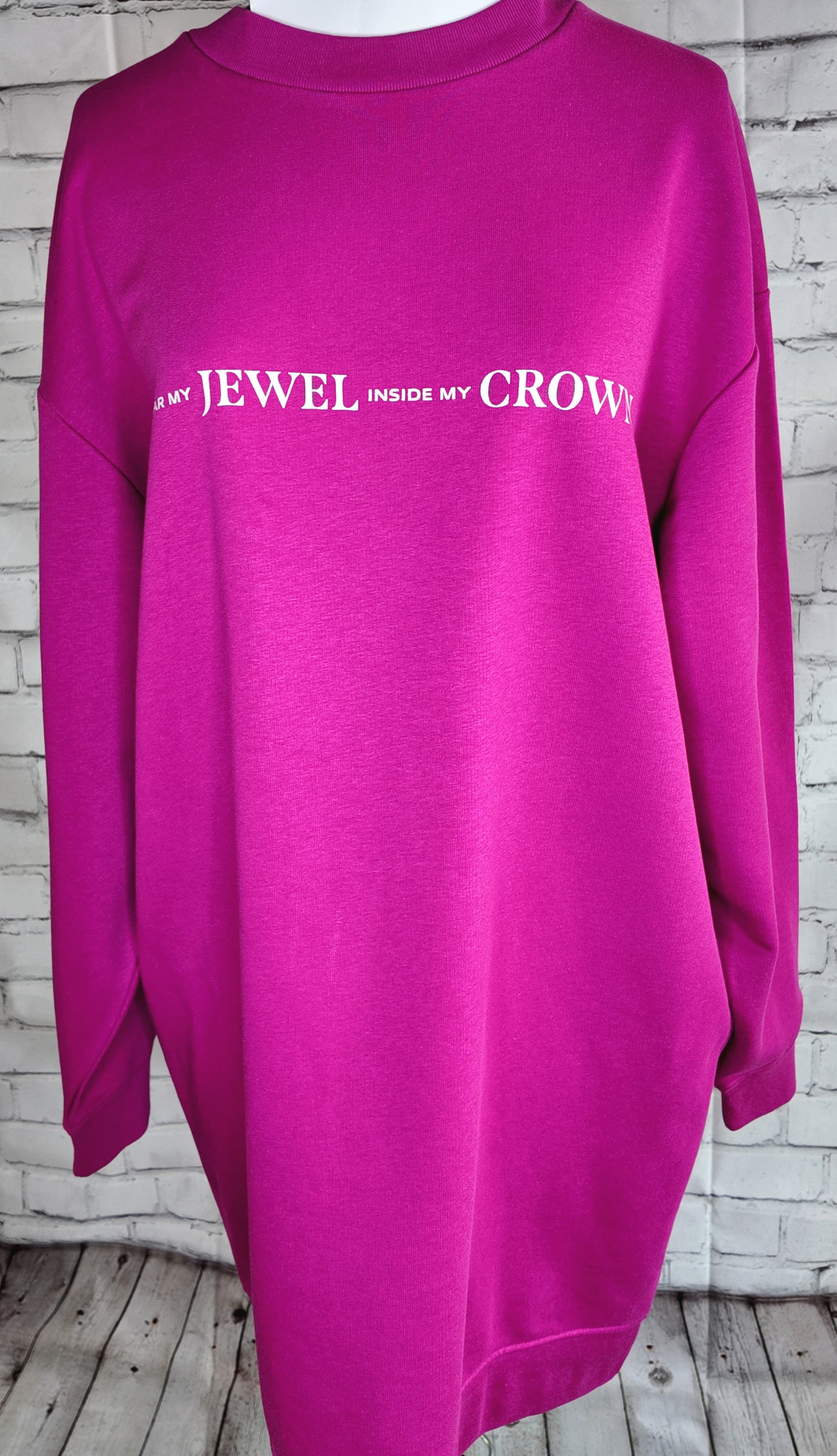 Product photo of the fuscia "I wear my jewel inside my crown" top, front view
