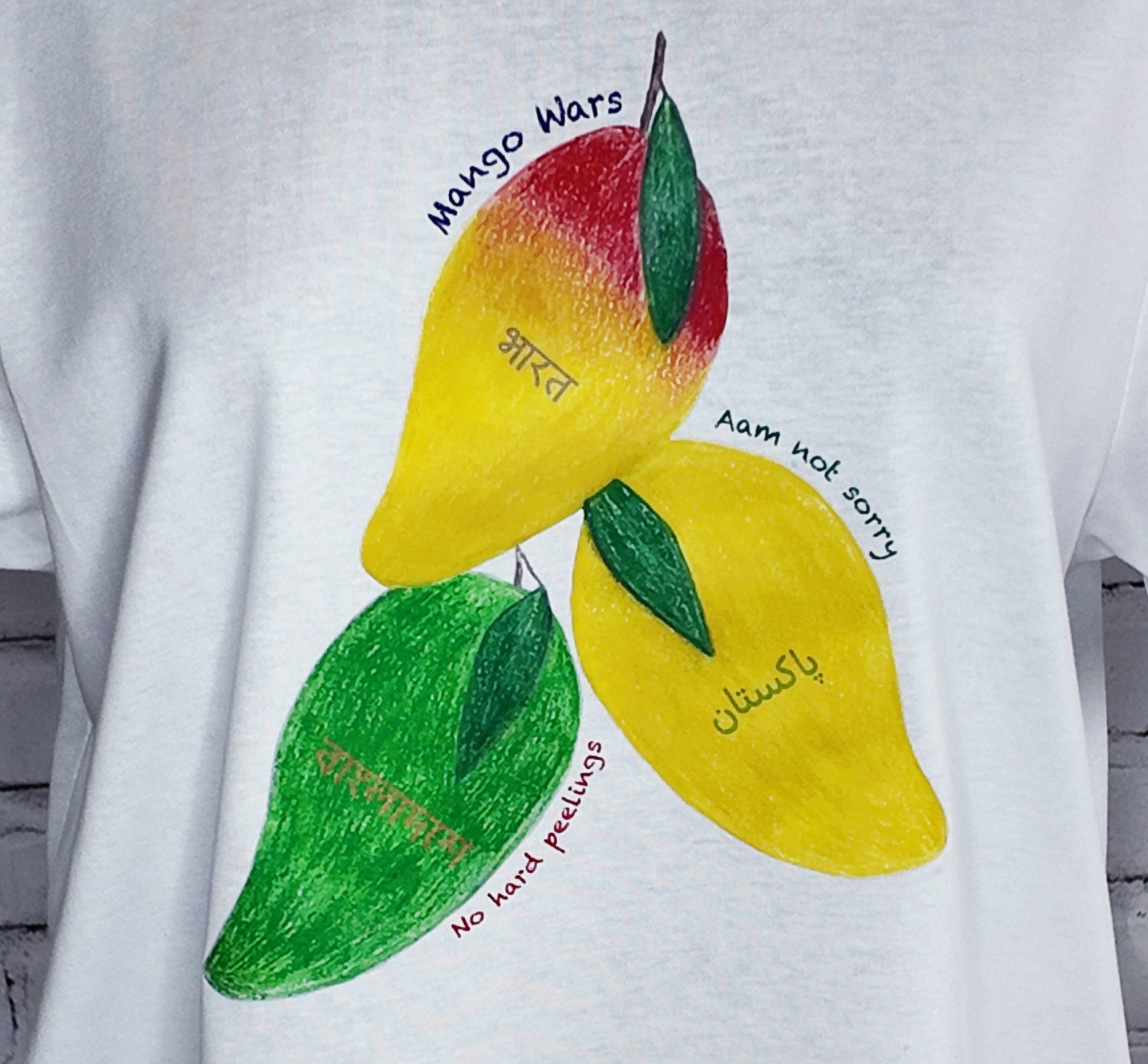 Close-up of the puns and mangoes on the tee