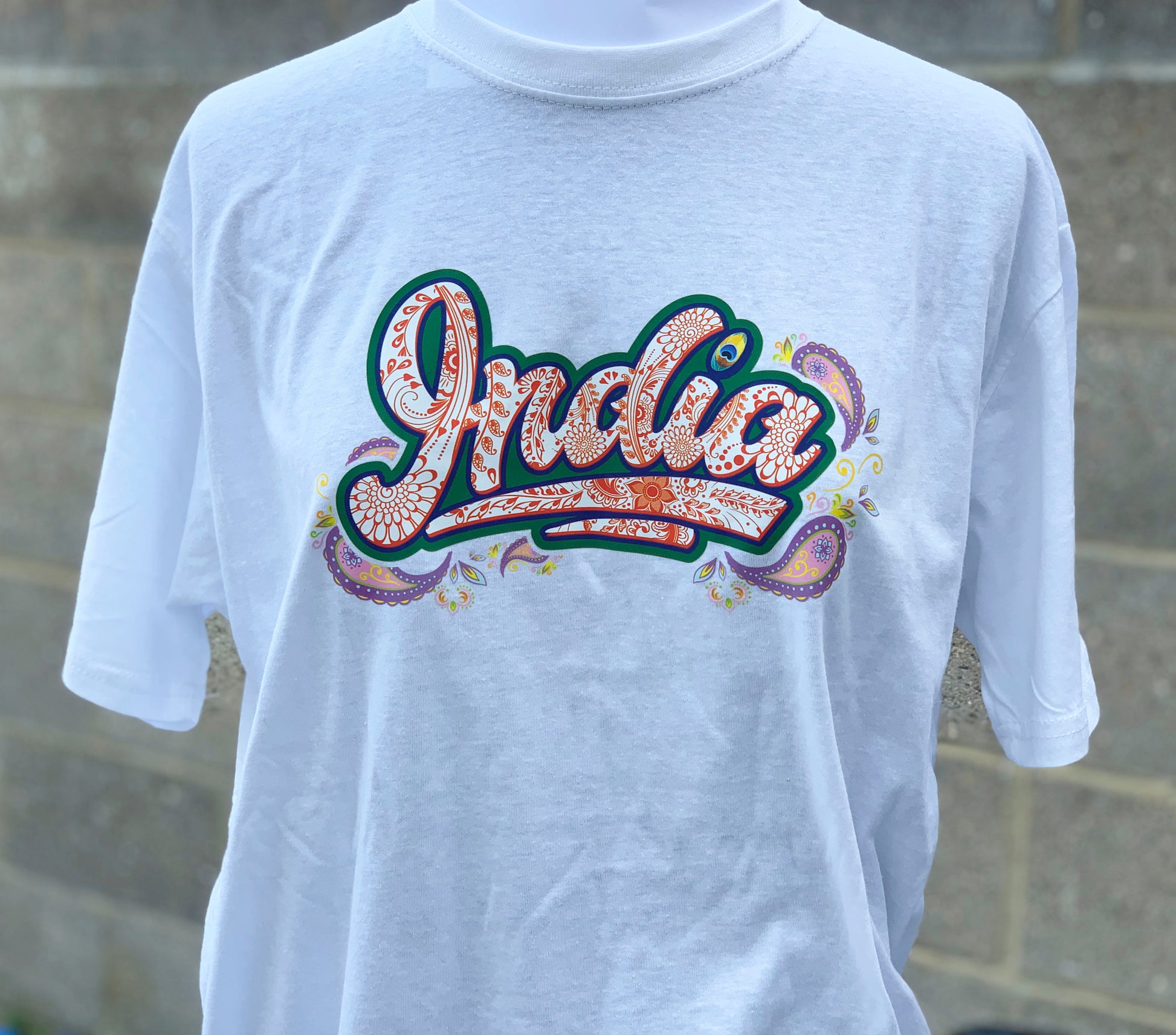 Close-up of henna pattern and paisley in graffiti India lettering